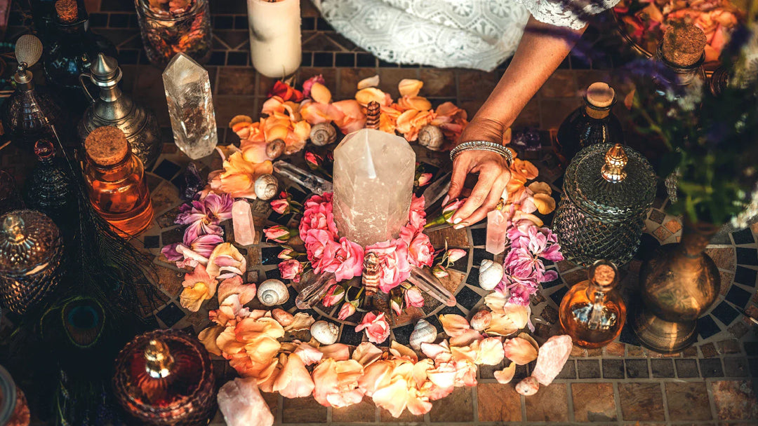 Colorful crystal altar layout with flowers and tools for spell casting and ritual work
