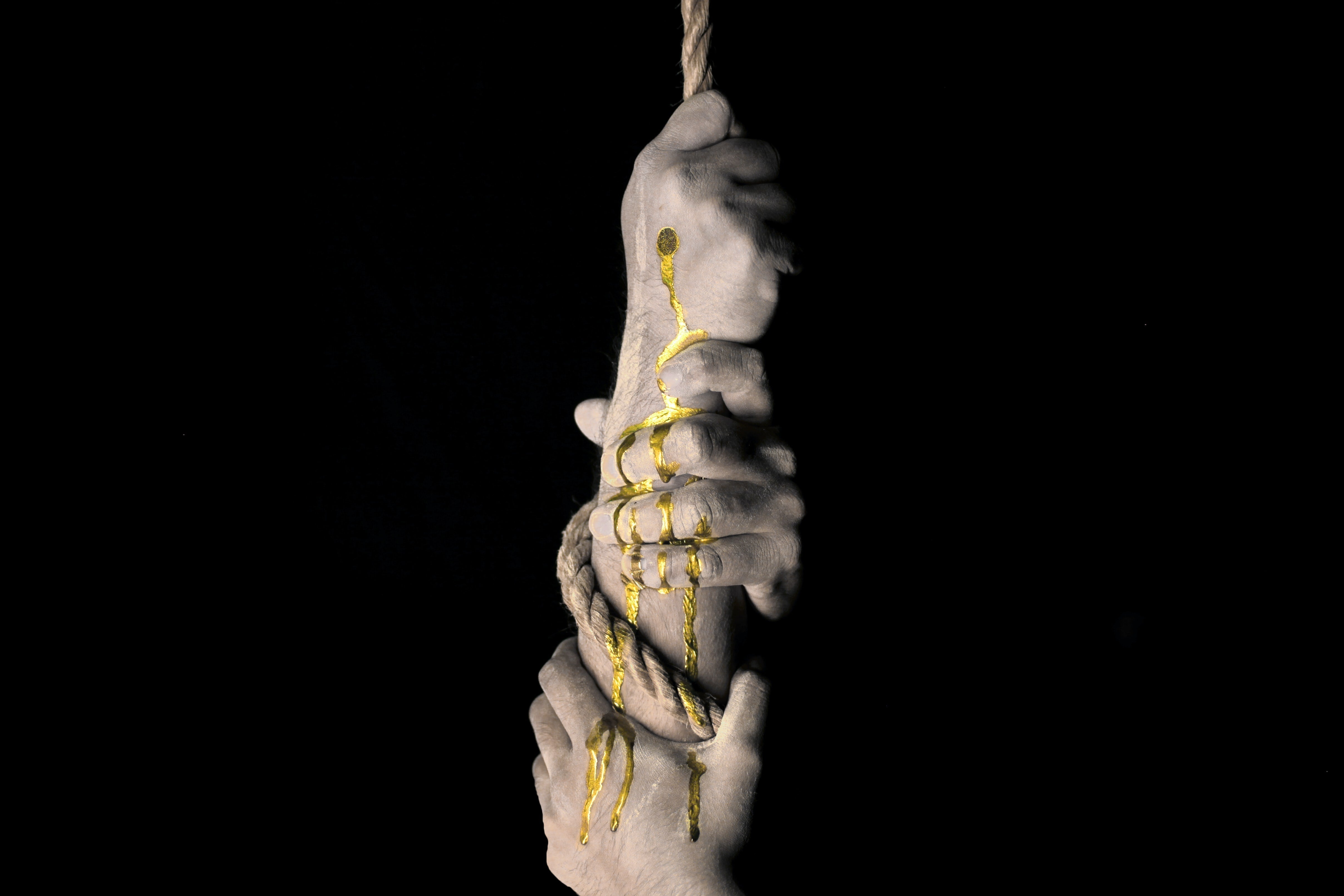 Hands on rope representing a full moon love binding spell.