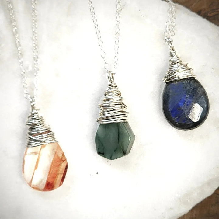 Sterling silver Red Quartz, Emerald, and Labradorite hand-wrapped gemstone necklaces.