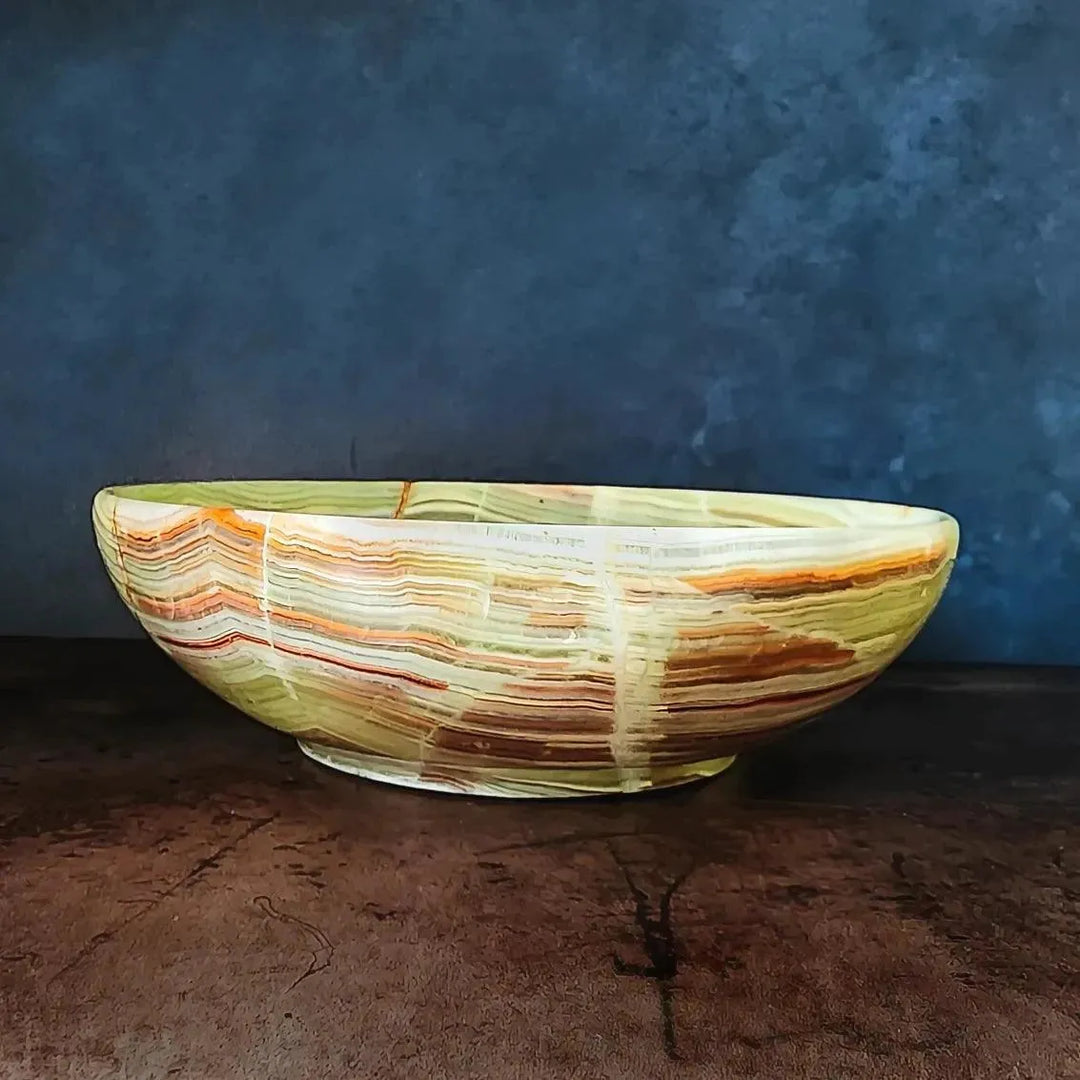 Side view of a beautiful green onyx crystal bowl from Art of the Root metaphysical supply store.