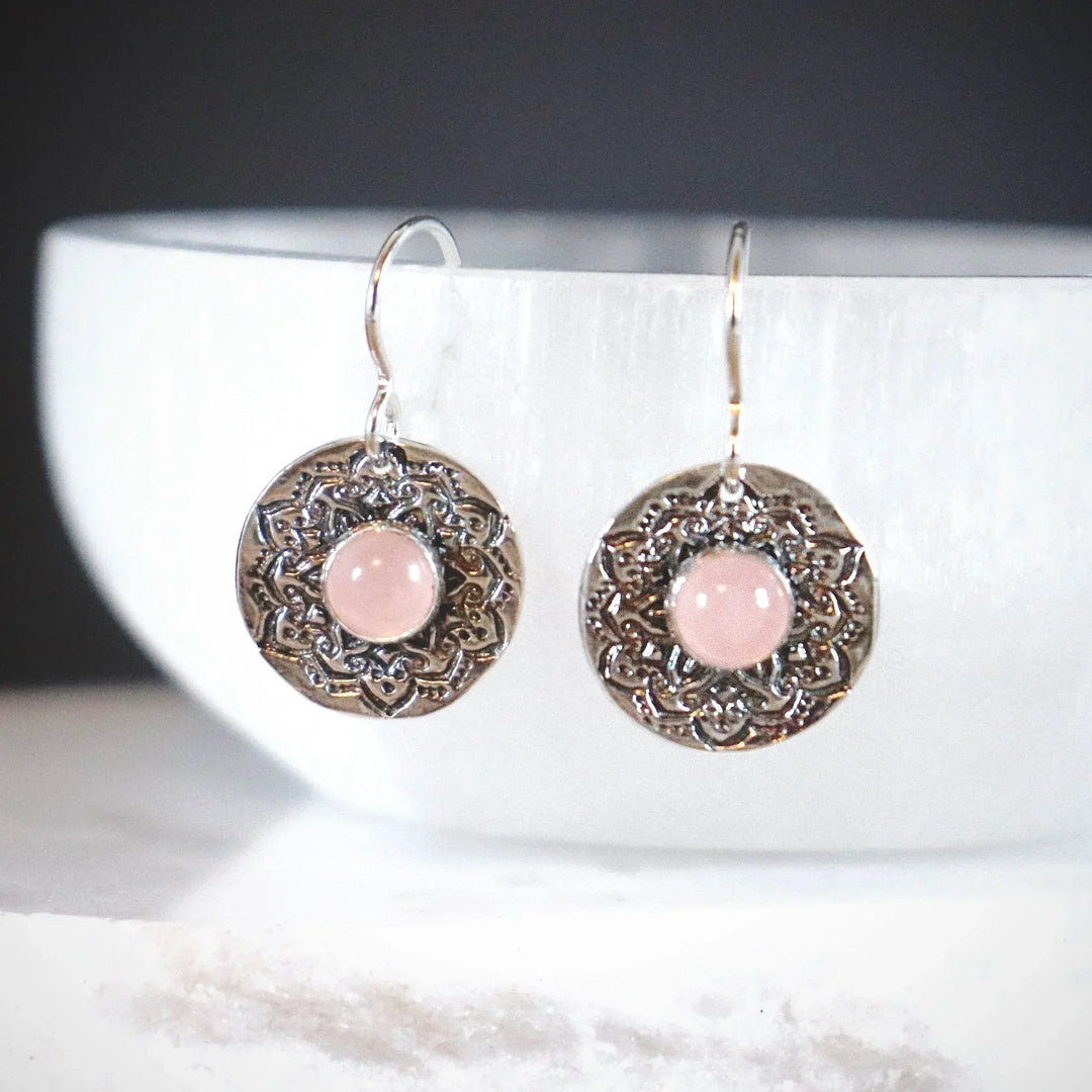 Rose Quartz Mandala Earrings in Fine Silver with Sterling Hooks Hanging on white stone.