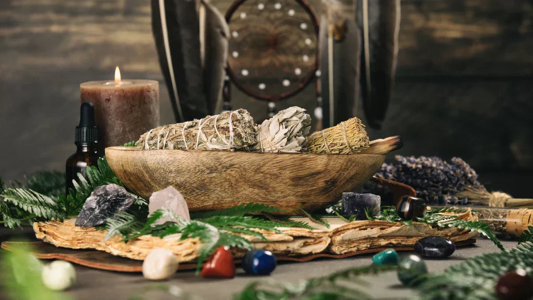 Spiritual hygiene ritual with sage smudge sticks, crystals, and candle for energy cleansing