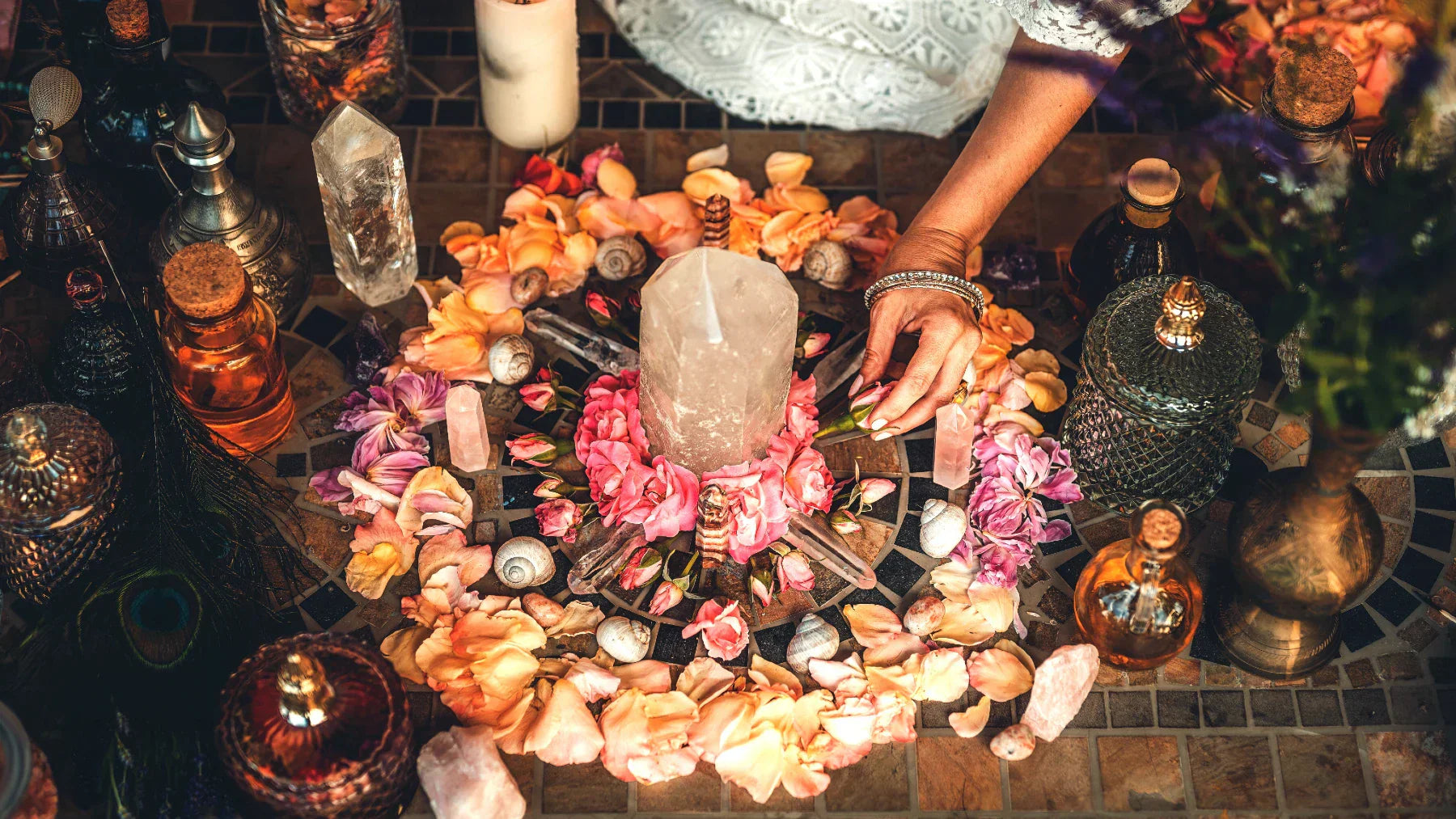 Colorful crystal altar layout with flowers and tools for spell casting and ritual work