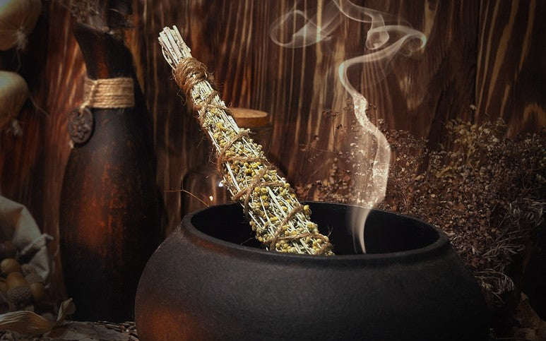 Mugwort in a cauldron. Read how to use Mugwort in witchcraft in this blog.