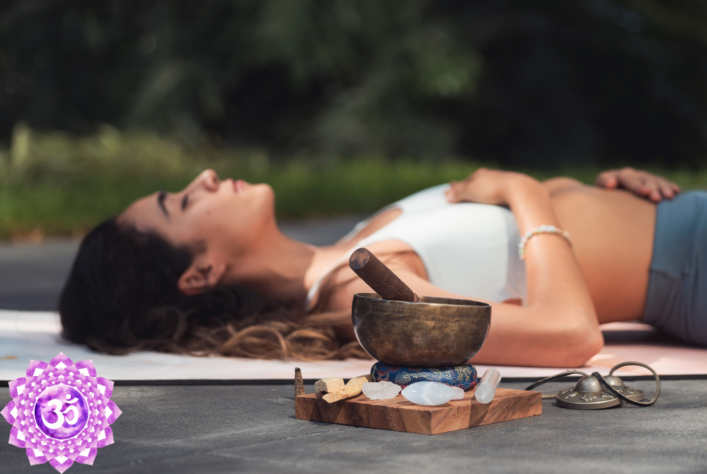 A woman meditating with Crown Chakra stones & crystals.