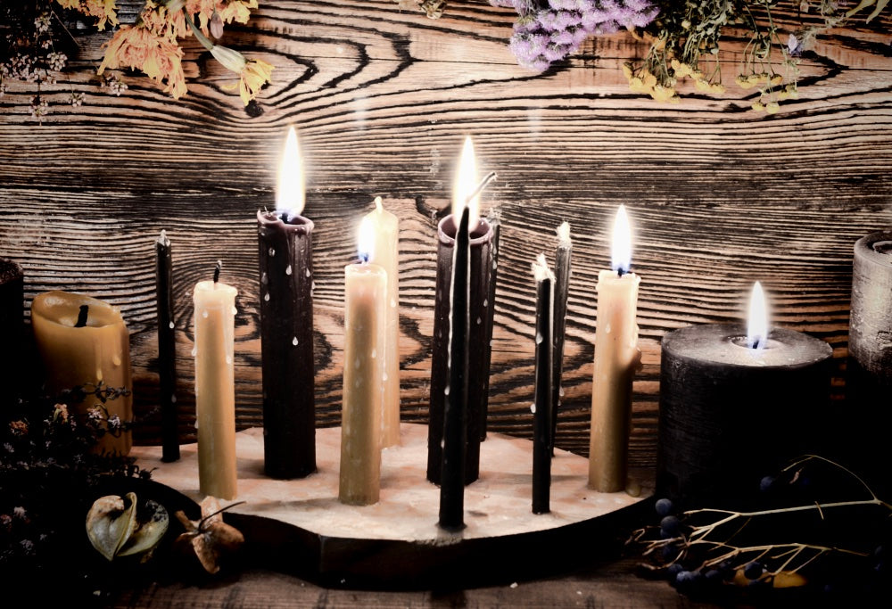 White & black candles being used for spells to banish someone. Read about banishing spells here.