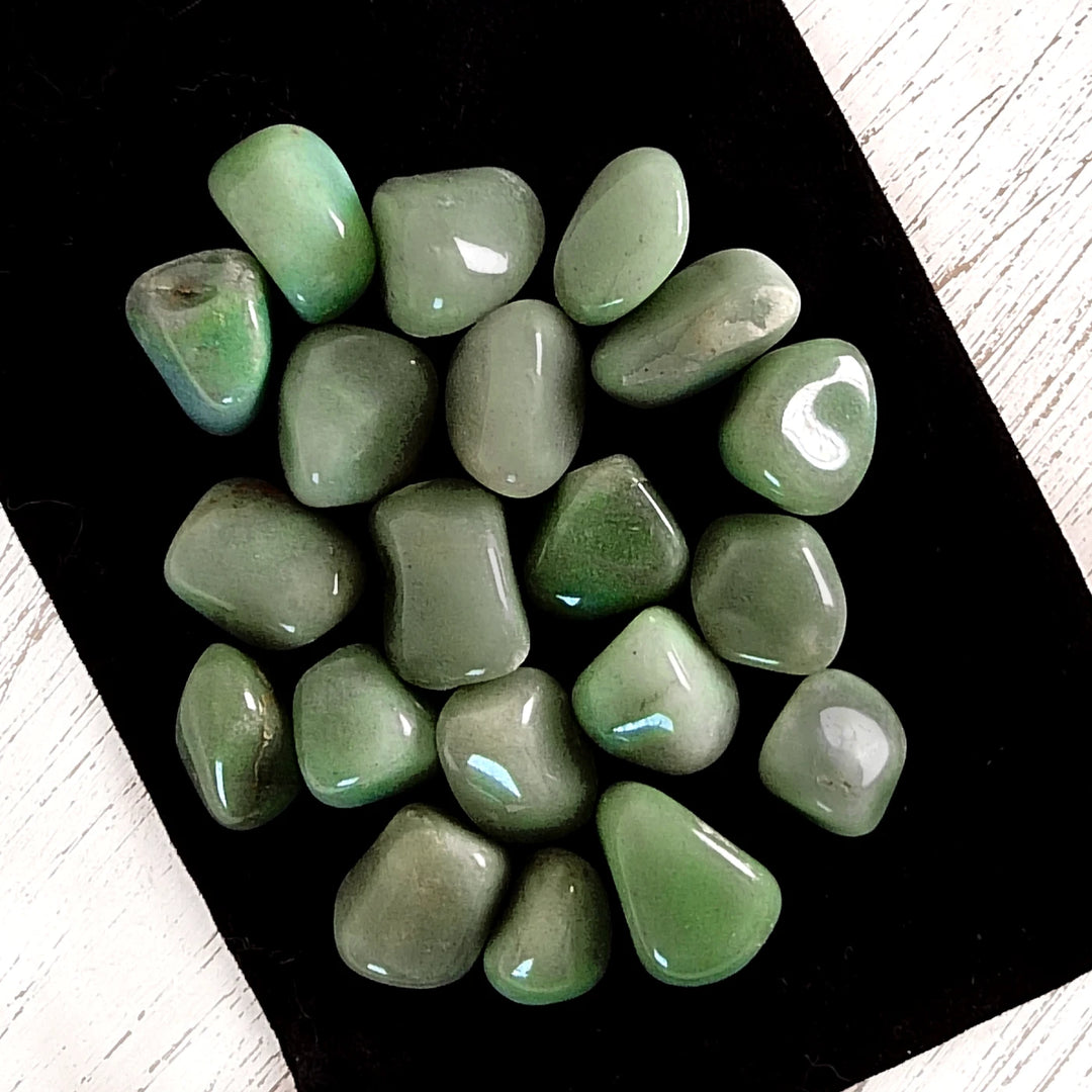 Polished, tumbled green aventurine crystals for self-love, luck, and abundance.