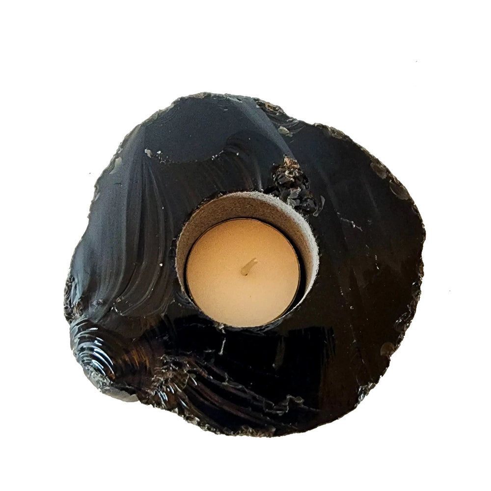 An Obsidian Candle holder with a tea light candle inside. Add it to your altar and use in rituals.