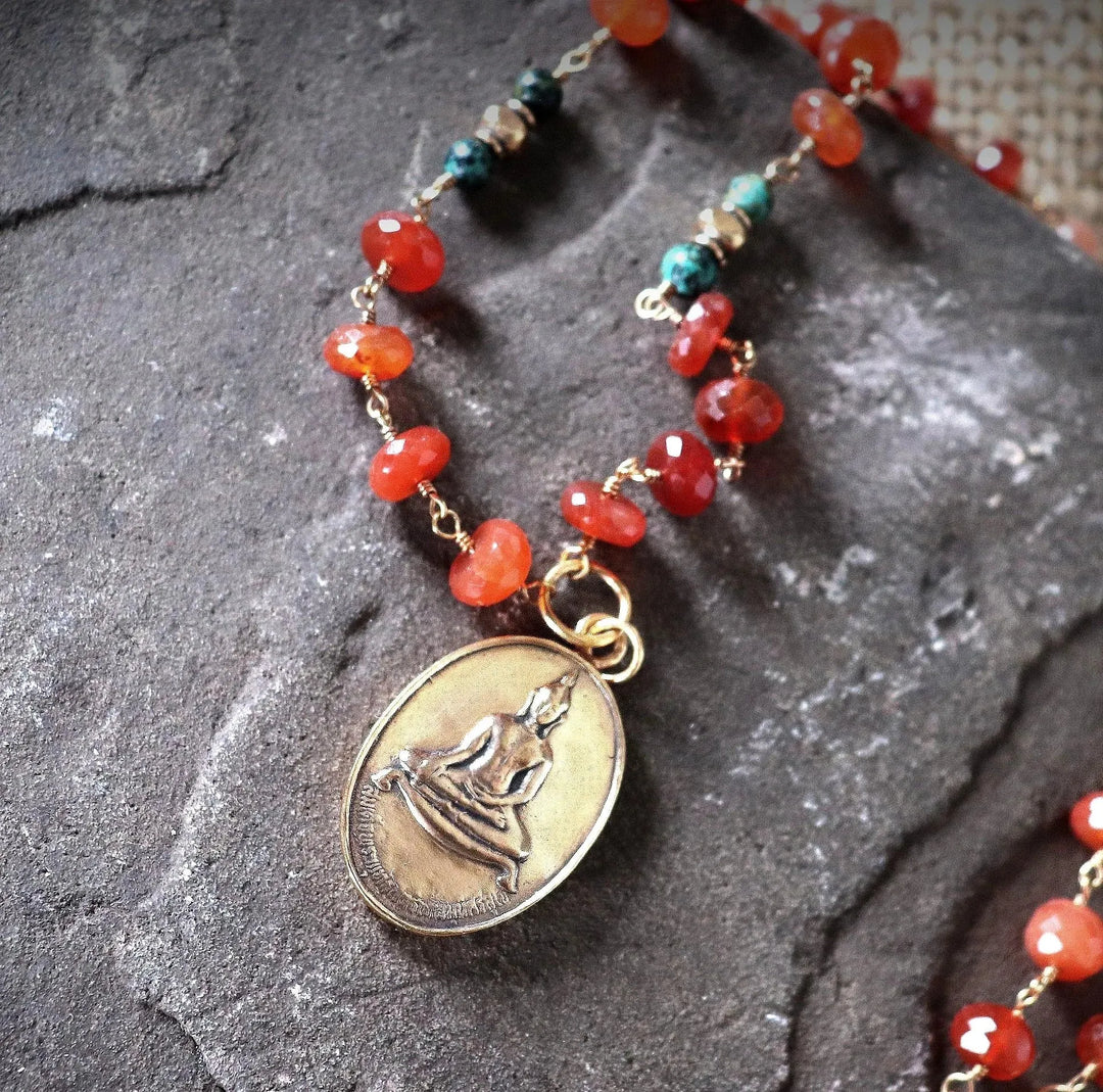 Carnelian Buddha necklace with African turquoise and red aventurine, gold-wrapped and featuring a bronze temple amulet, 24 inches, by Art of the Root