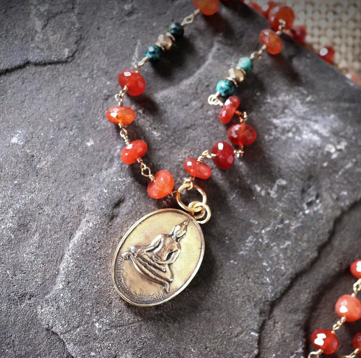 Carnelian Buddha necklace with African turquoise and red aventurine, gold-wrapped and featuring a bronze temple amulet, 24 inches, by Art of the Root