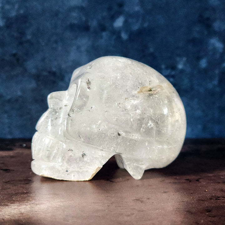 A side profile view of a solid clear quartz crystal skull from Art of the Root.