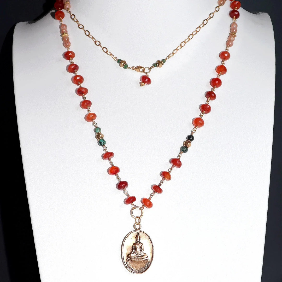 Carnelian and African Turquoise Necklace with Bronze Temple Buddha Charm on White Bust.