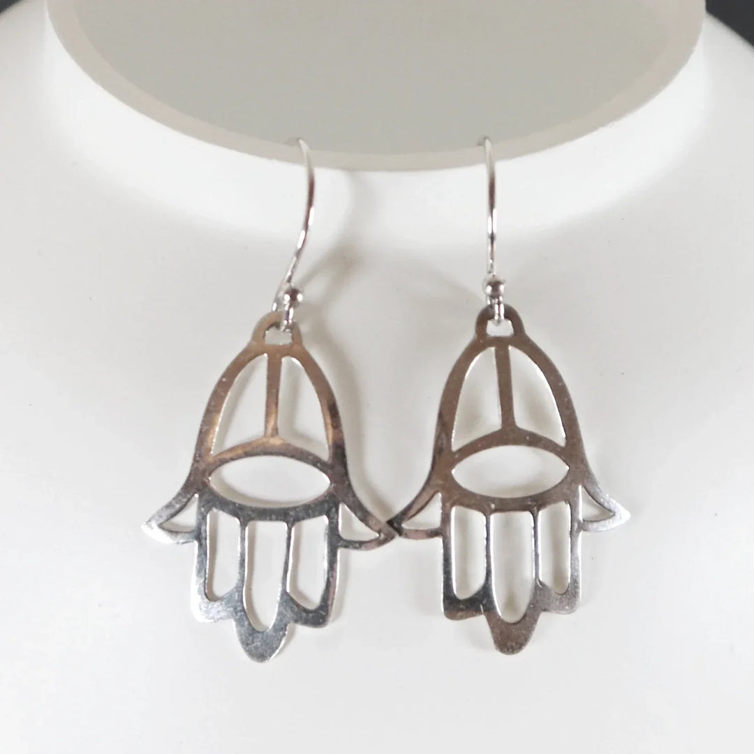 Fine Silver Hamsa Earrings Hanging on White Jewelry Display