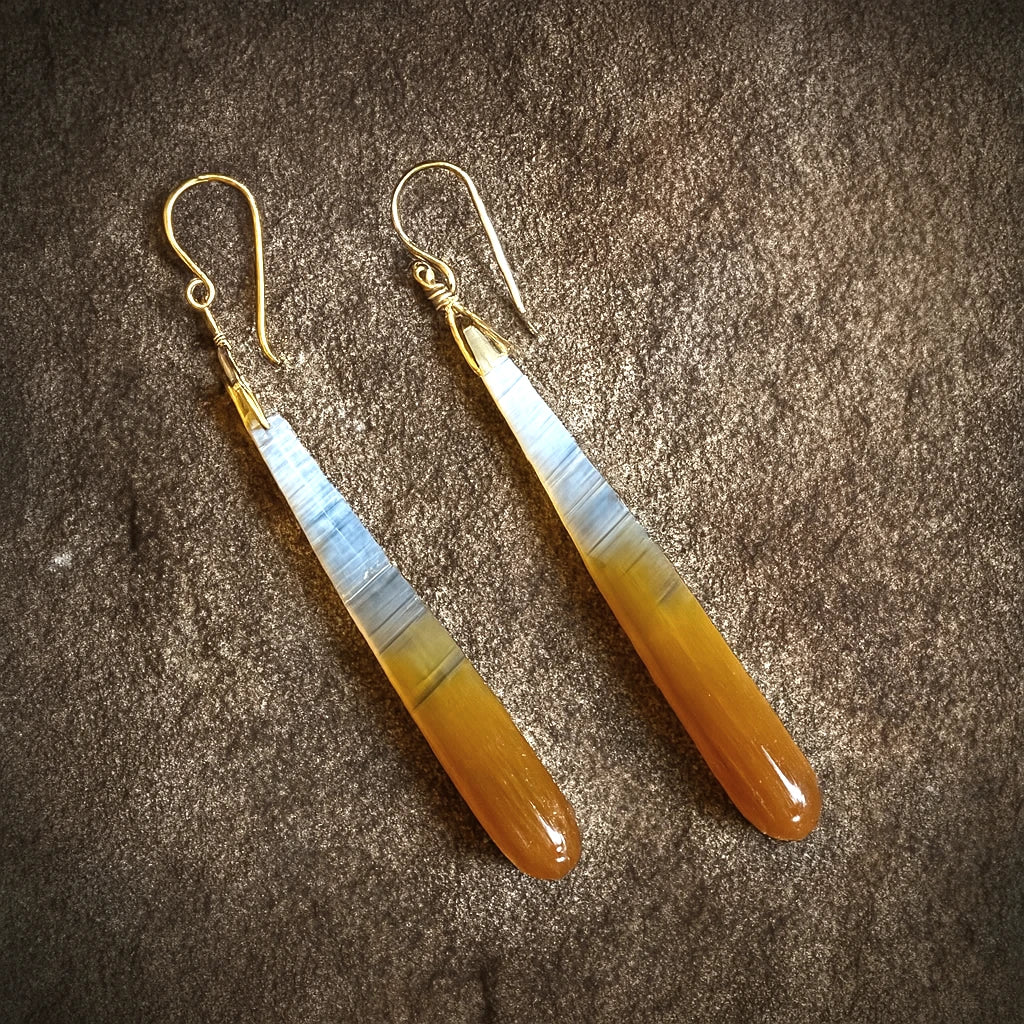 Banded Crystal Agate Dangle Earrings on Stone Background in Natural Light