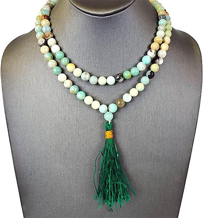 An Amazonite bead necklace on a jewelry mannequin.