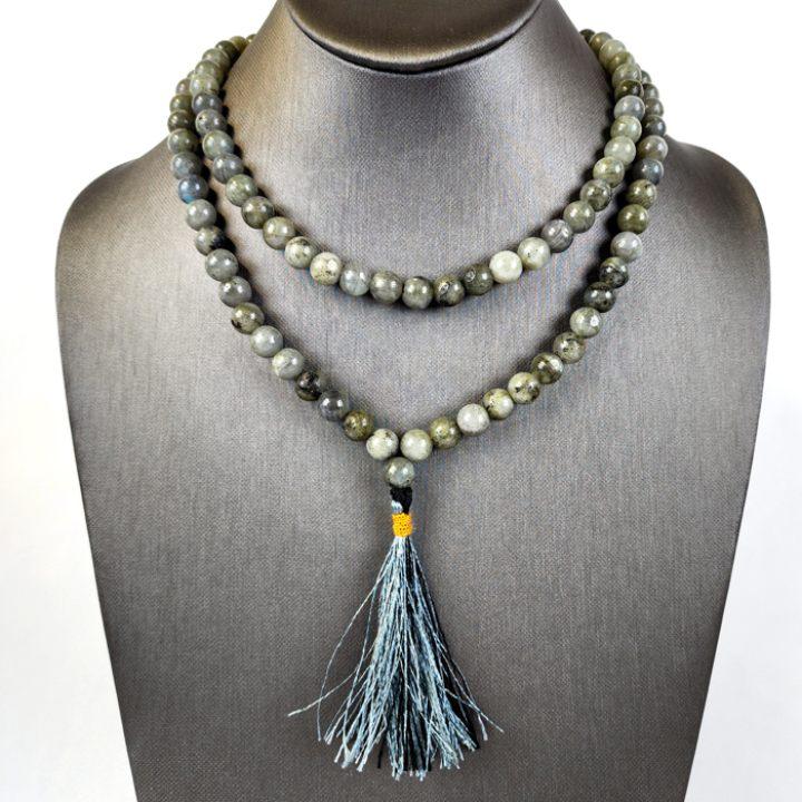 A jewelry mannequin wearing Art of the Root green Labradorite Beads as a necklace.