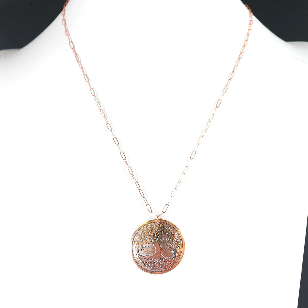 Necklace with a tree of life pendant on a white background