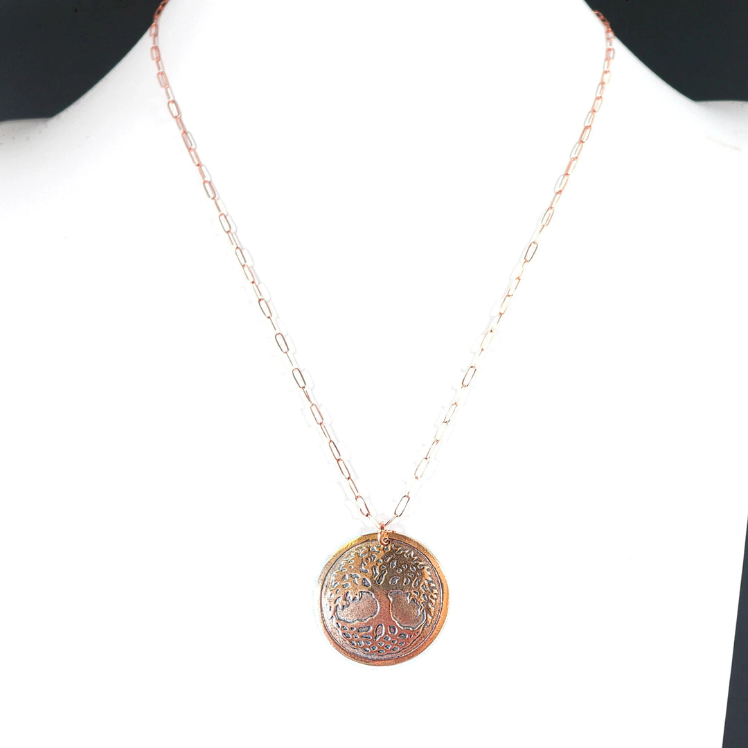 Necklace with a tree of life pendant on a white background