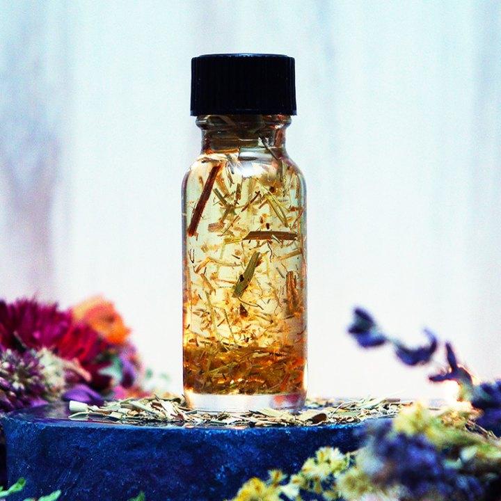 A clear bottle of Art of the Root's Van Van Oil. Shop this and other handmade conjure oils here.